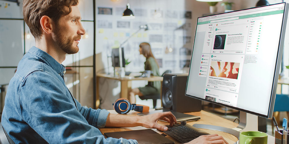 Man working on computer looking at graphics