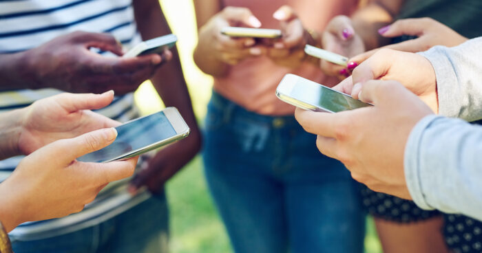 Teenagers on mobile phones.